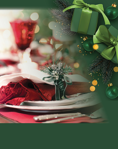 Holiday table setting with a red napkin, evergreen centerpiece, and festive green ornaments.