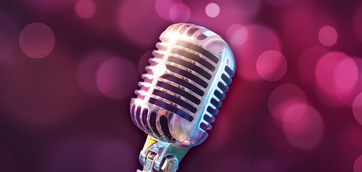 Old school microphone on a rose colored background
