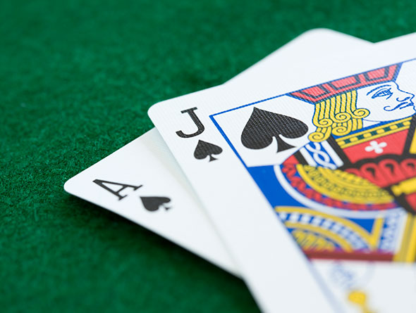 blackjack cards on green felt