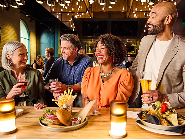 a group dining and having drinks at 90NINETY