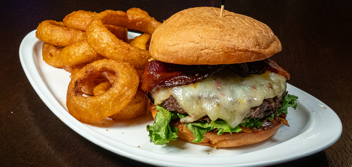 Wagyu Burger with grilled onions, pepper jack cheese, candied bacon, and house-made sauce