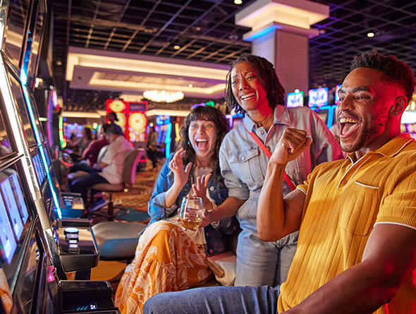 group playing slot machines