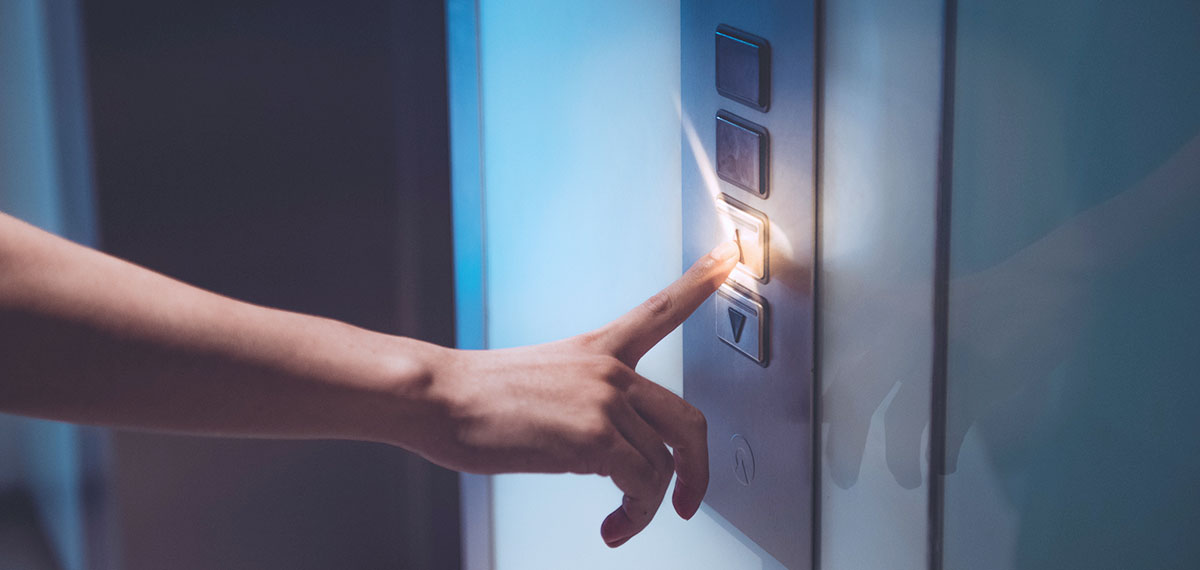 hand pressing elevator button