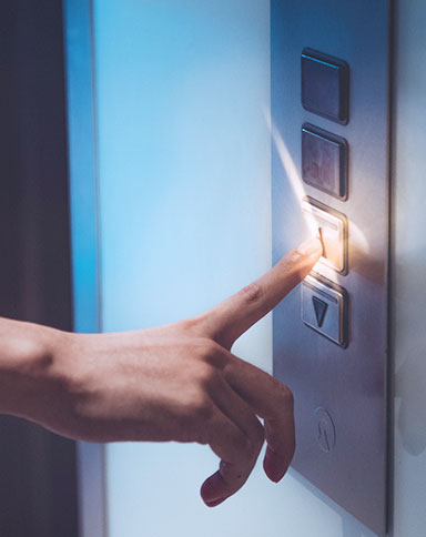hand pressing elevator button