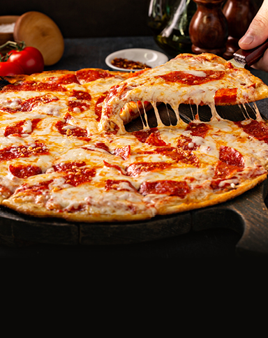 Image of a pizza slice being lifted from a whole pizza