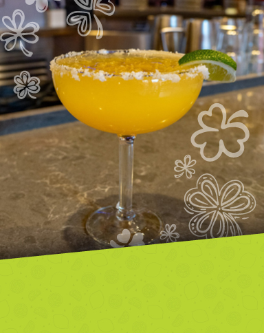 A golden-orange cocktail made with Mi Campo Reposado, house sour mix, Grand Marnier, Cointreau, and orange juice.