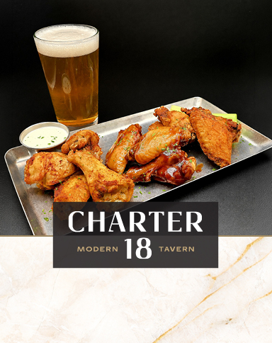Chicken wings, dipping sauce, and a draft beer at Charter 18 Modern Tavern.