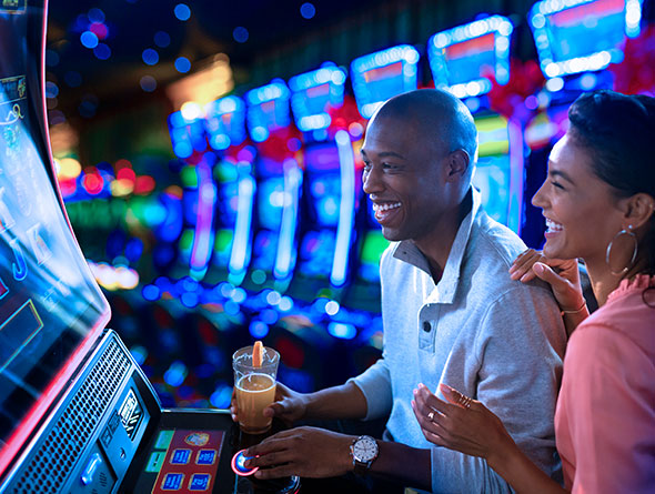 Couple playing slot machines image
