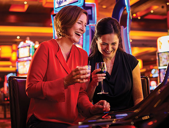 Two Women Playing Slots