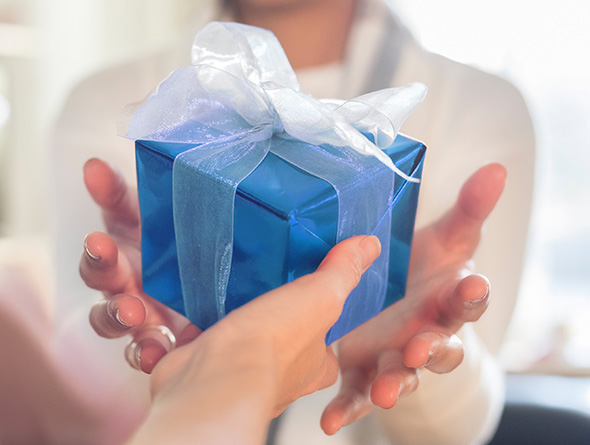 women giving each other a gift from a Boyd retail location