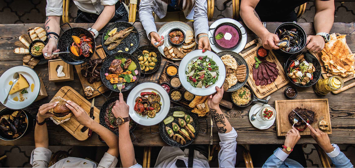 people eating a variety of food at the table