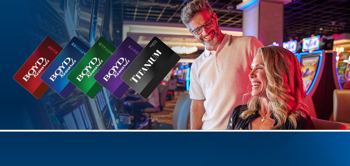 couple playing slots with boyd rewards cards