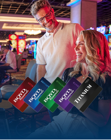 couple playing slots with boyd rewards cards