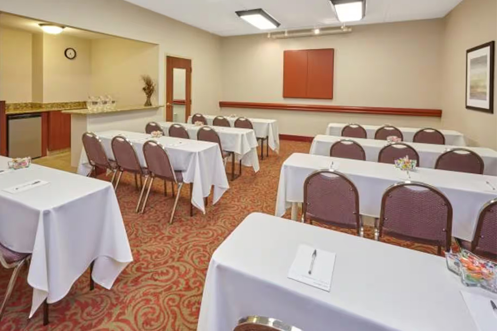 classroom style meeting room with tables and chairs at paradice inn
