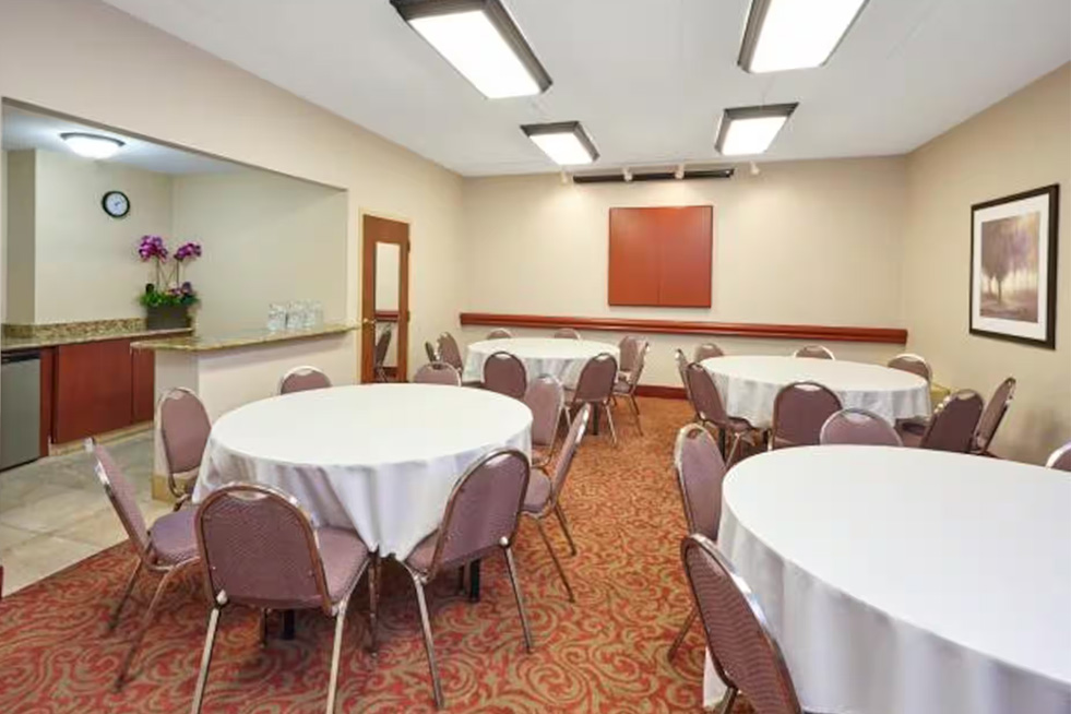 classroom style meeting room with round tables and chairs at paradice inn