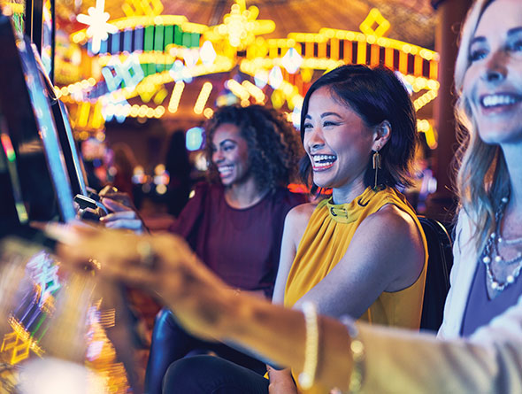 Three women playing slots image