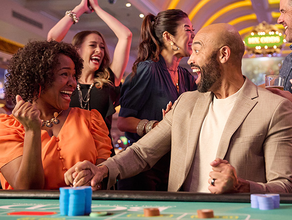 a group cheering at a Boyd roulette table